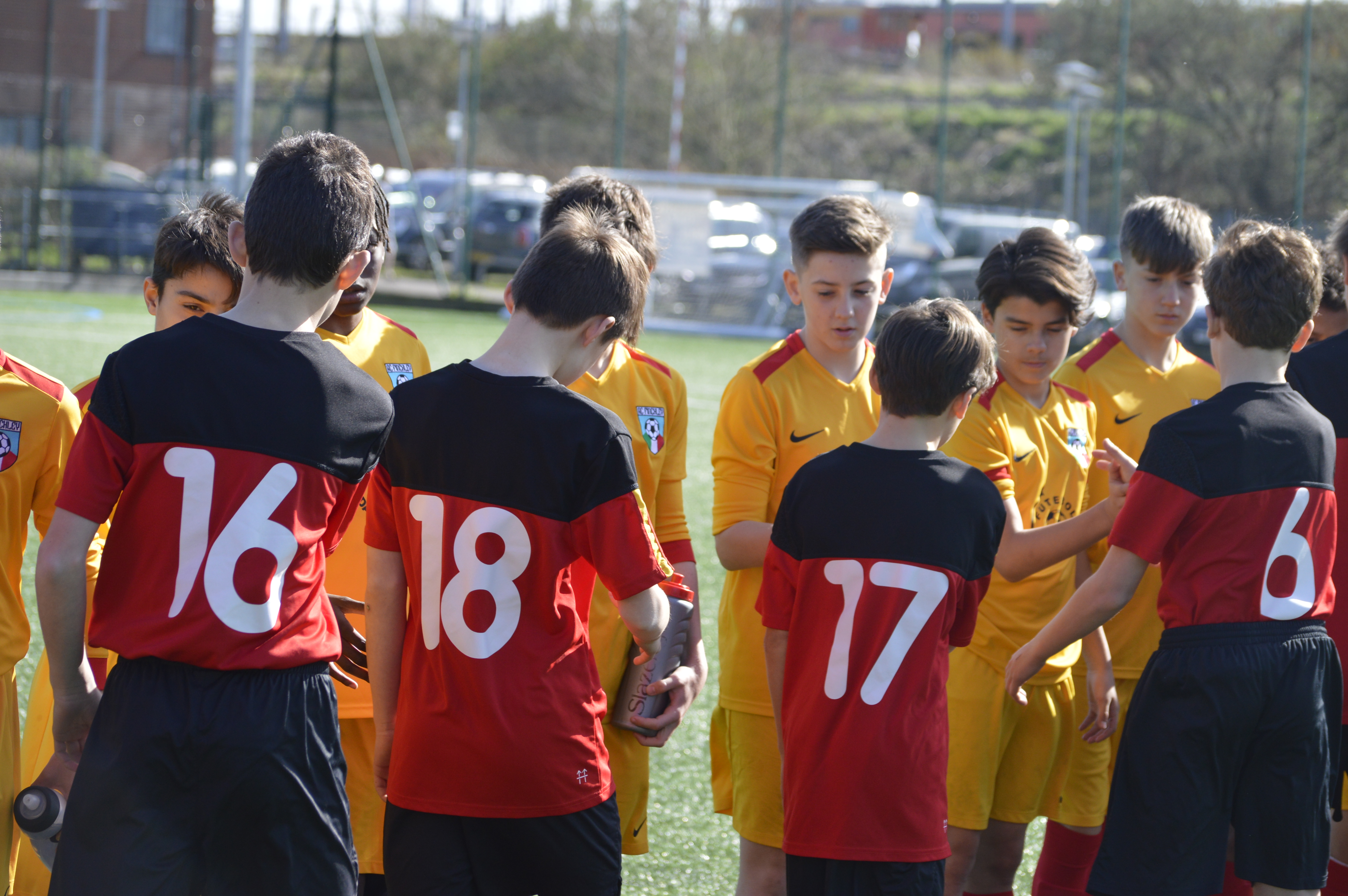 Youth football team huddle